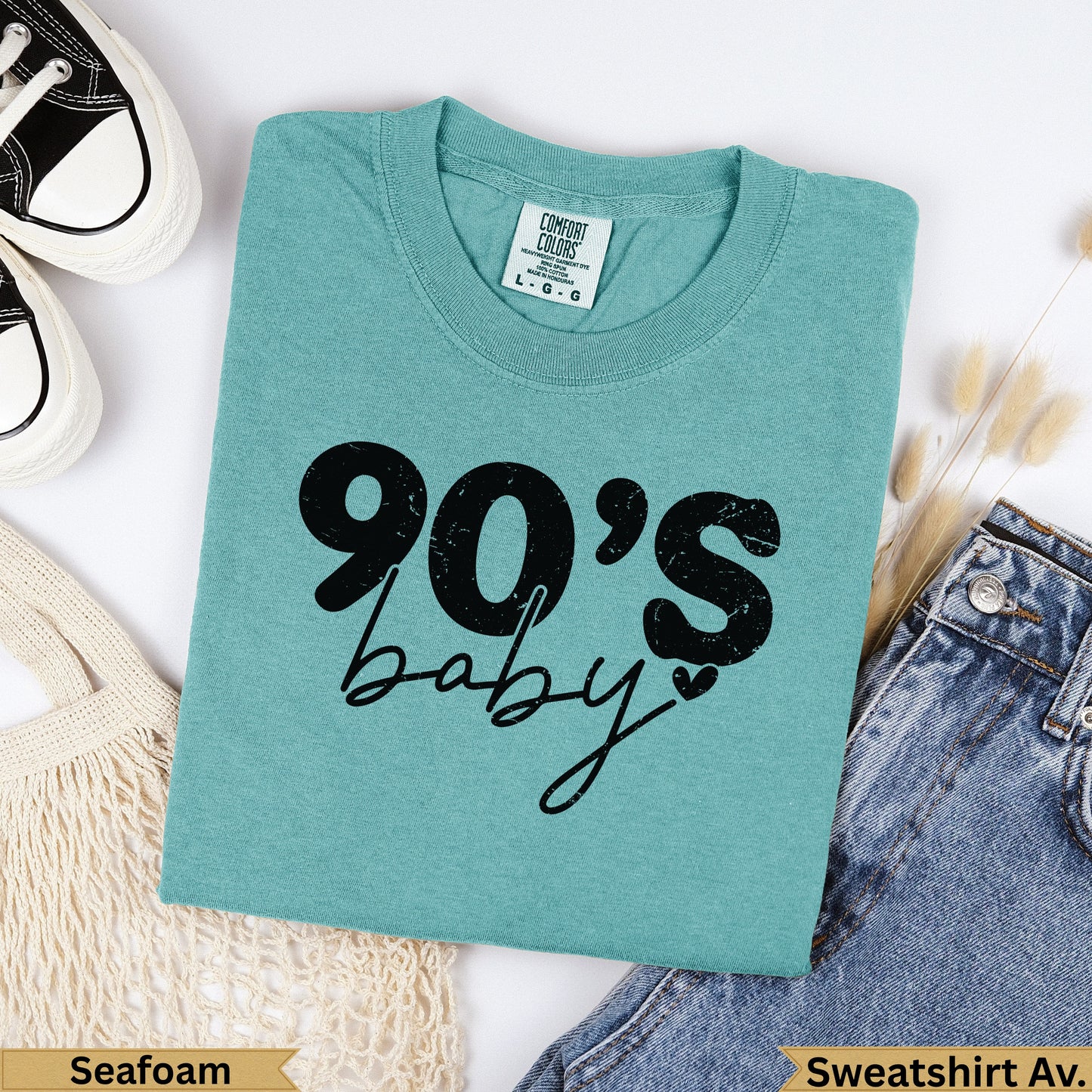 Teal "90's baby" graphic sweatshirt with denim and canvas bag.