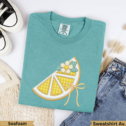 Teal Comfort Colors sweatshirt with a yellow gingham lemon slice graphic.