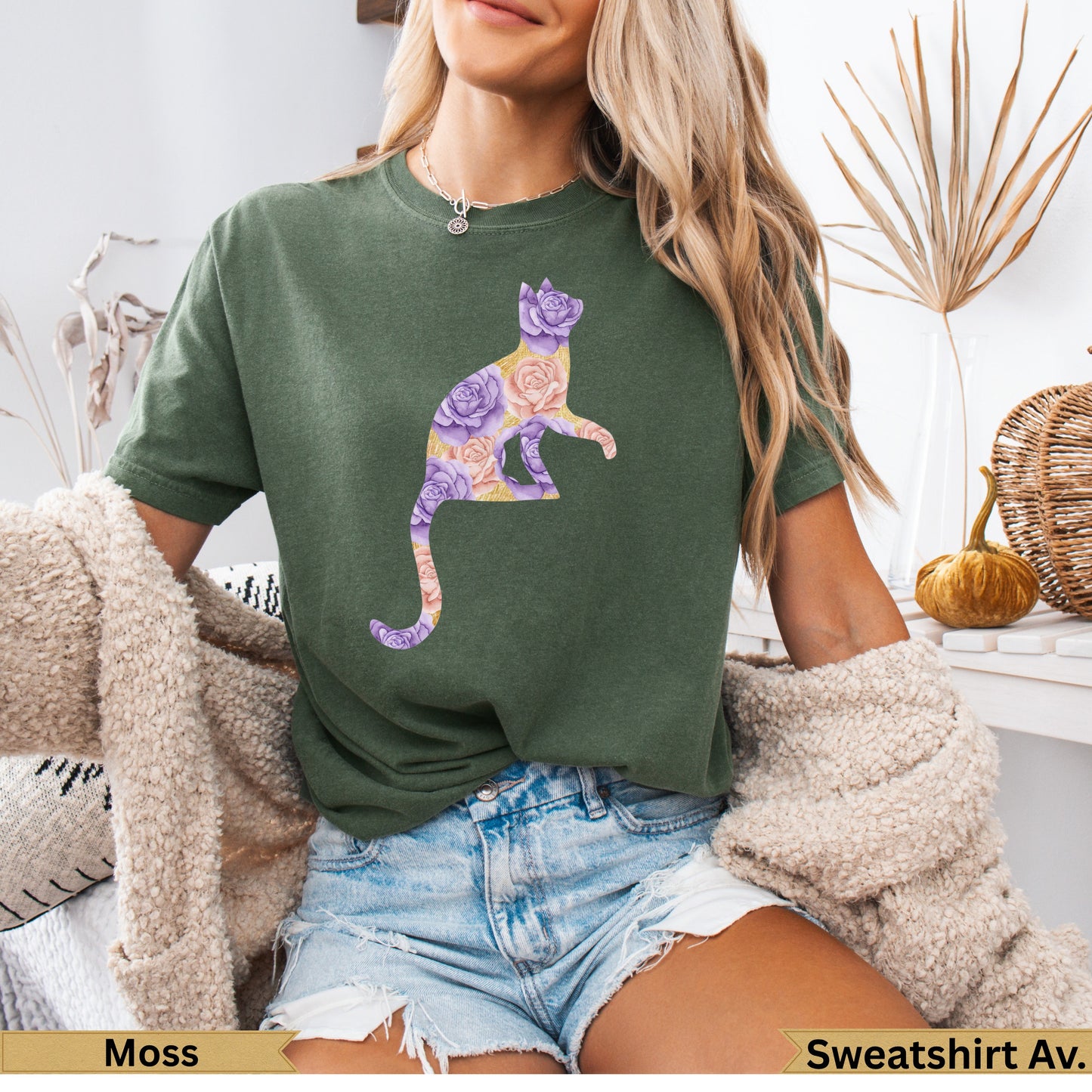 Olive green t-shirt with a floral cat silhouette in pink and purple.