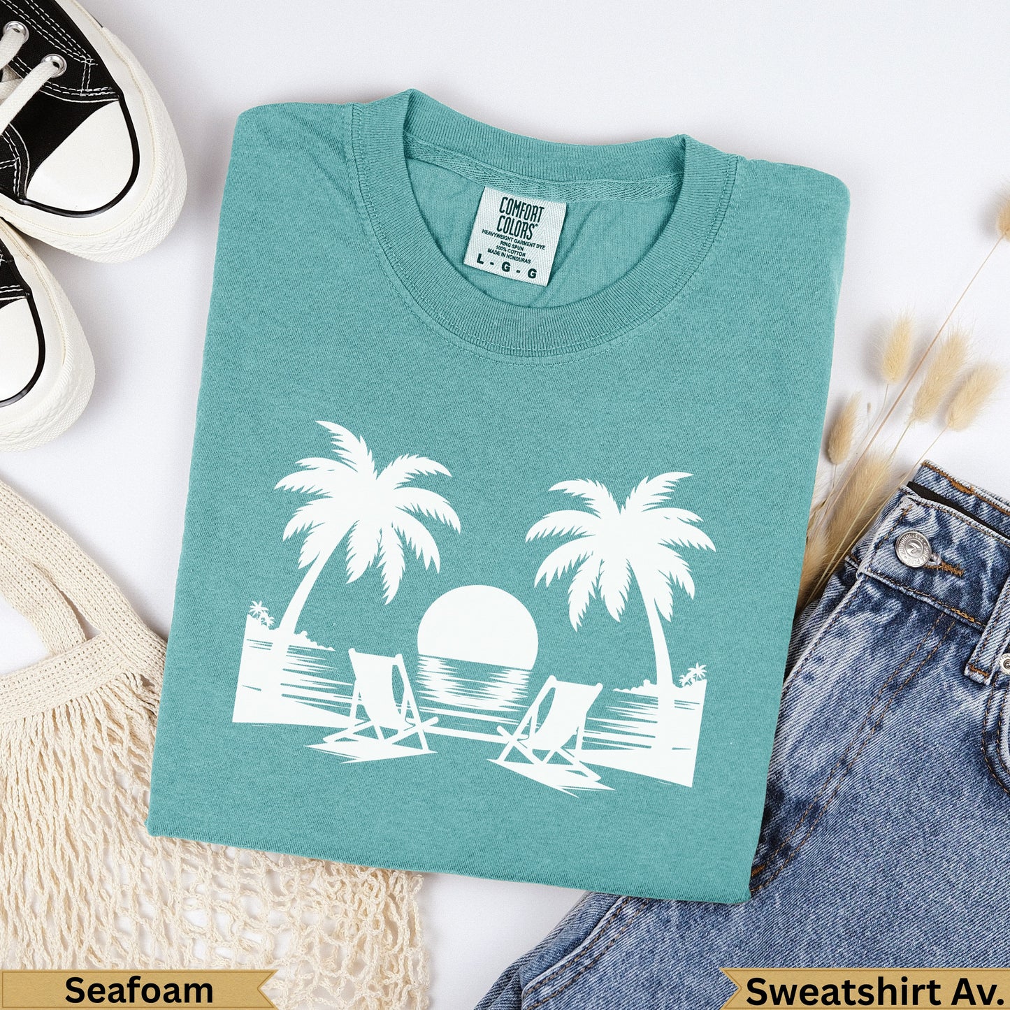 Teal Comfort Colors sweatshirt with palm trees, chairs, and ocean graphic.
