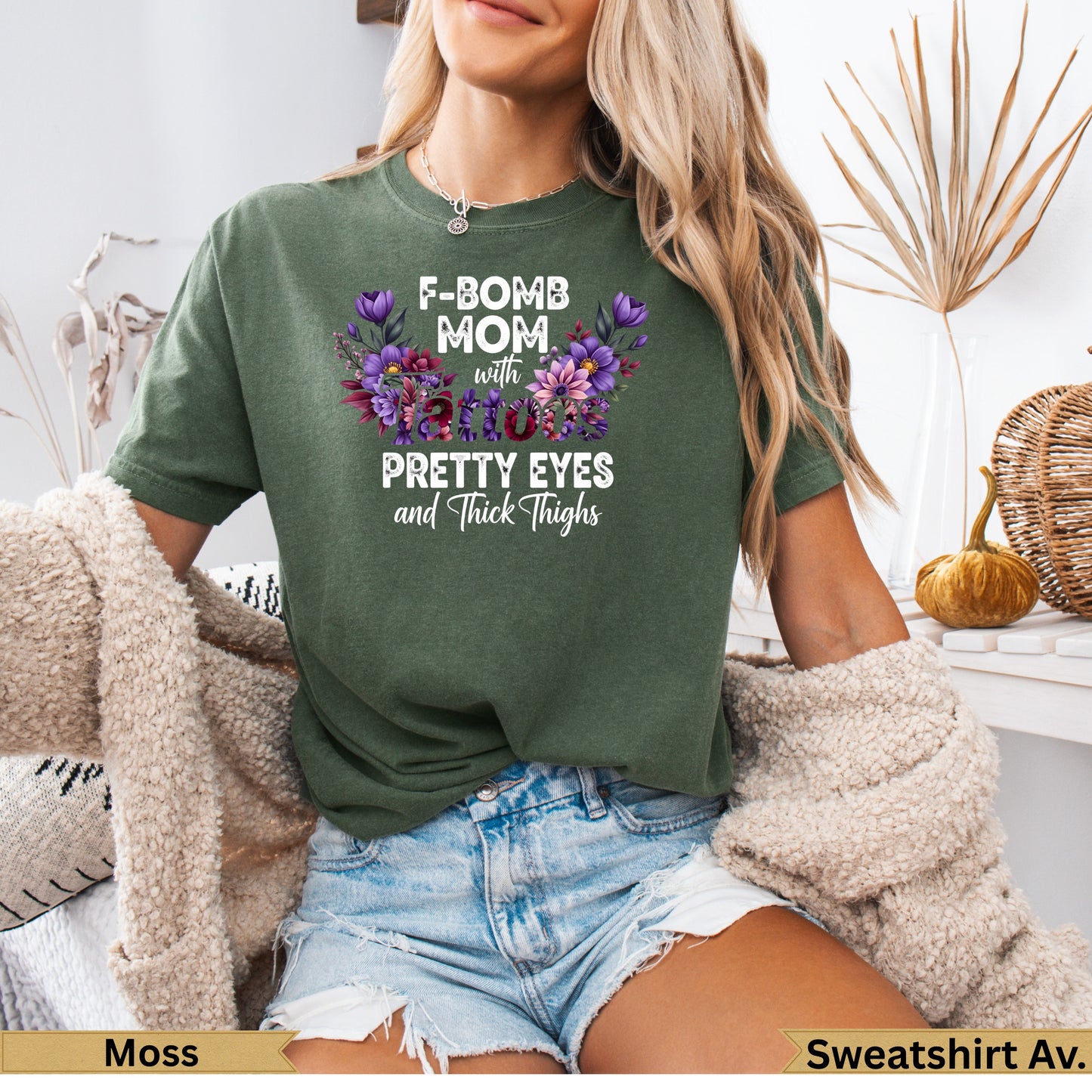 F-Bomb Mom with Pretty Eyes and Thick Thighs graphic tee with floral design.