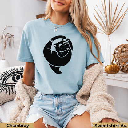 Light blue t-shirt with a black cat graphic, displayed on a model.