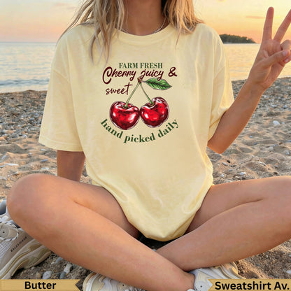 Light yellow sweatshirt with cherries and text: "FARM FRESH Cherry juicy & sweet hand picked daily"