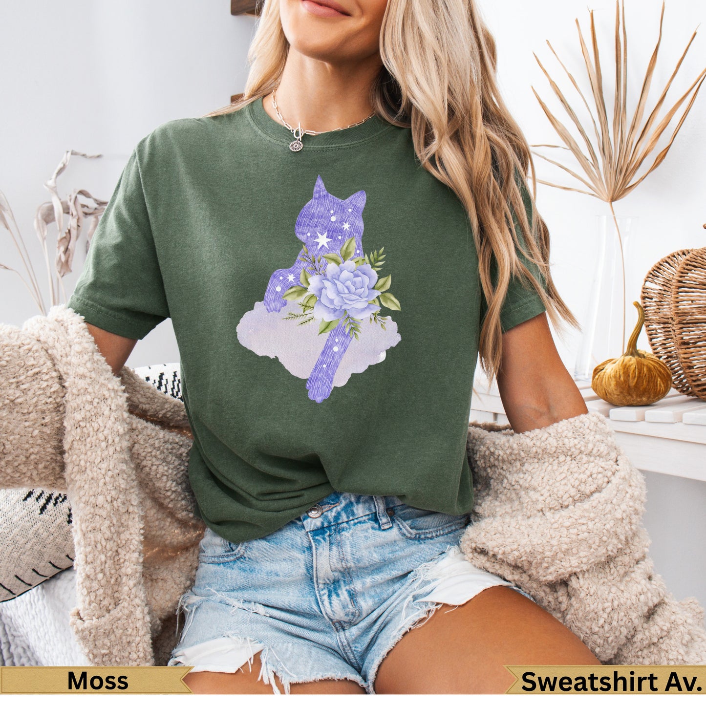 Green t-shirt with a purple cat silhouette and floral accents.