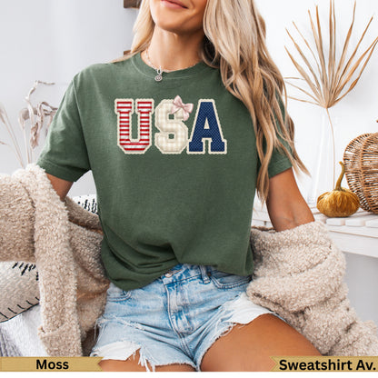 Green t-shirt with red, white, and blue "USA" graphic and plaid accents.