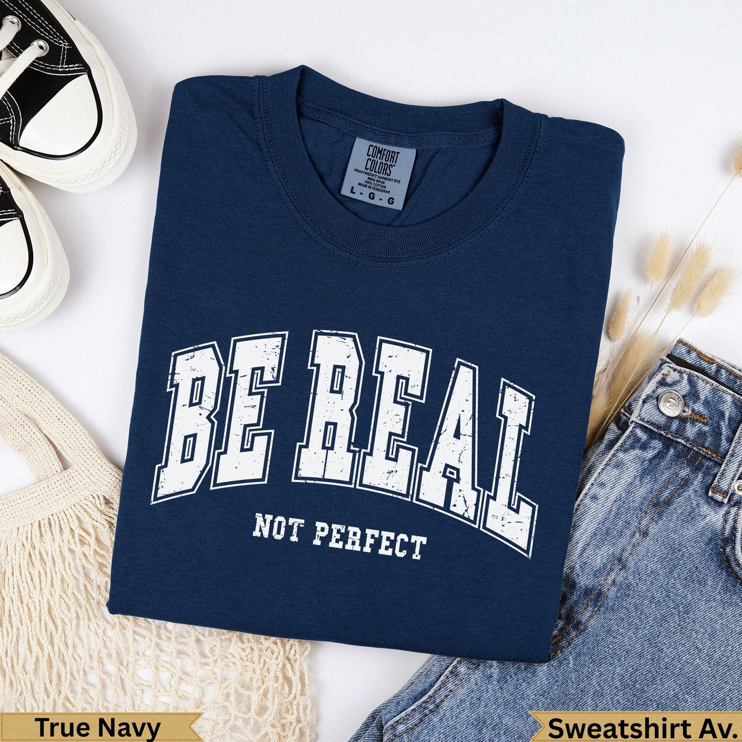 Navy blue Comfort Colors sweatshirt with "BE REAL NOT PERFECT" text.