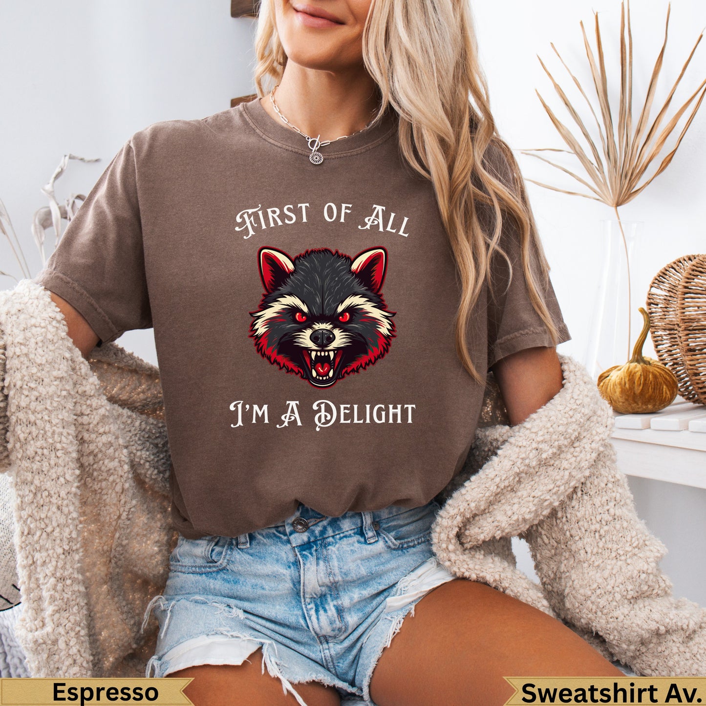Brown t-shirt with raccoon graphic and text "First of All I'm A Delight".