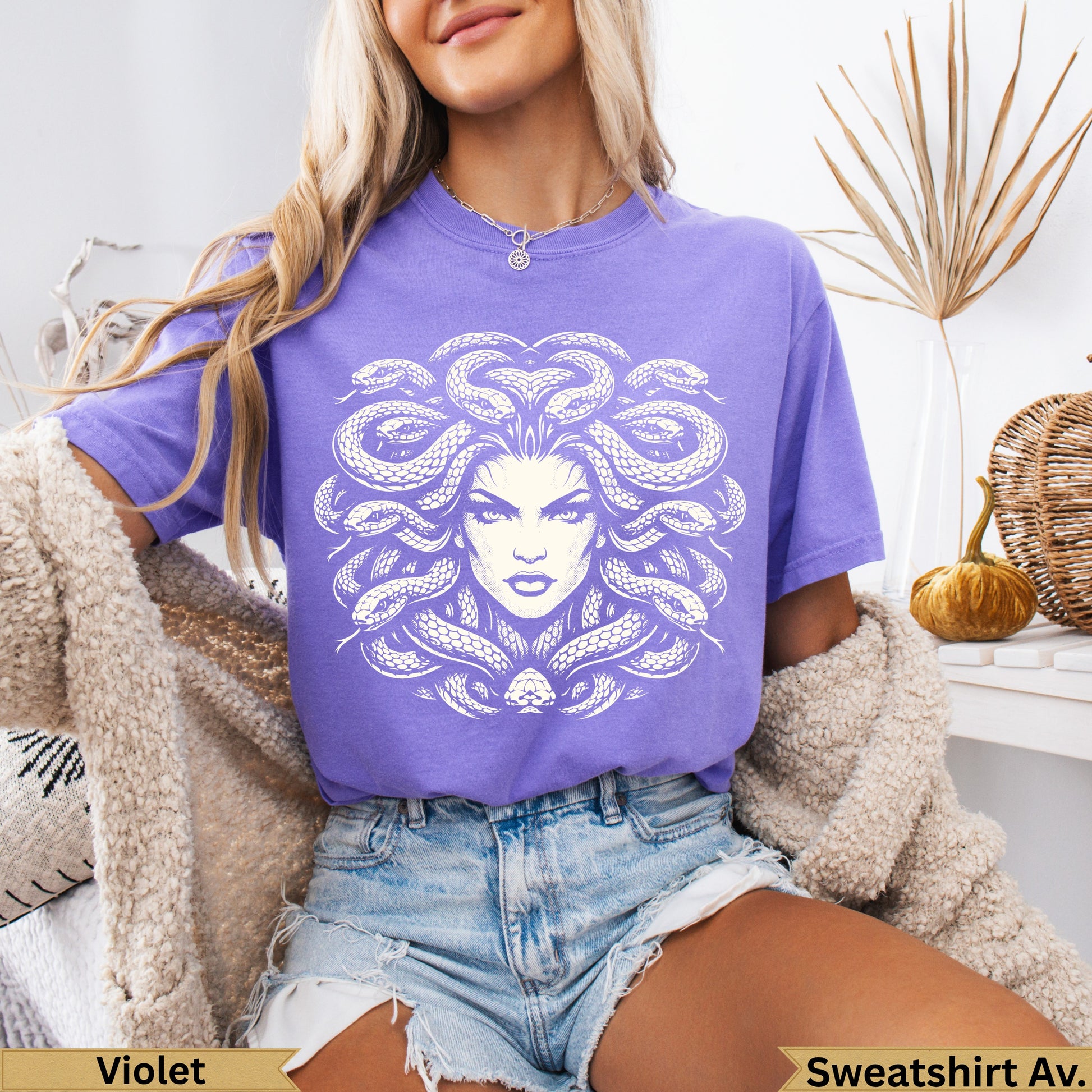 Purple t-shirt with white Medusa head graphic.