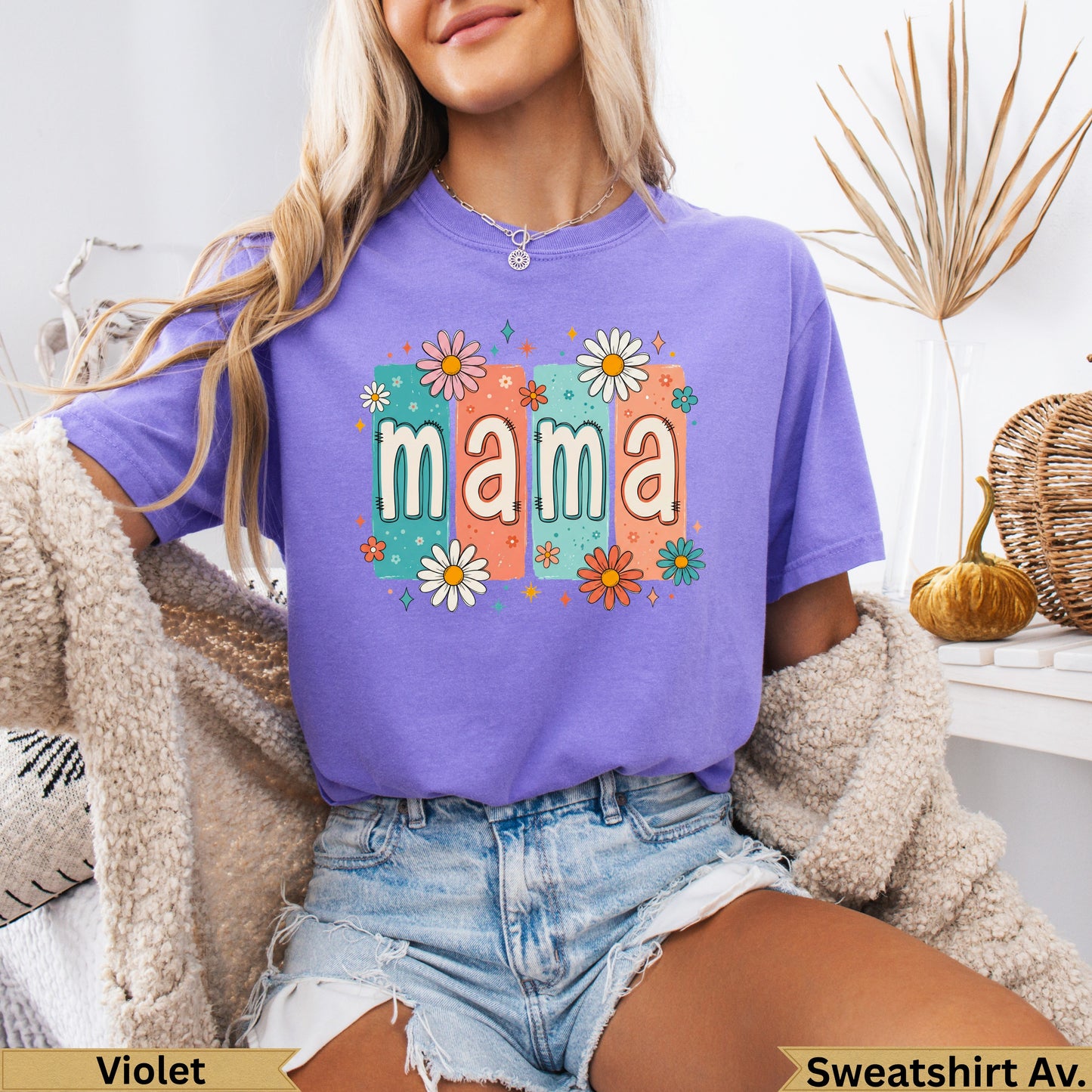 Purple t-shirt with "mama" in colorful retro font and floral accents.