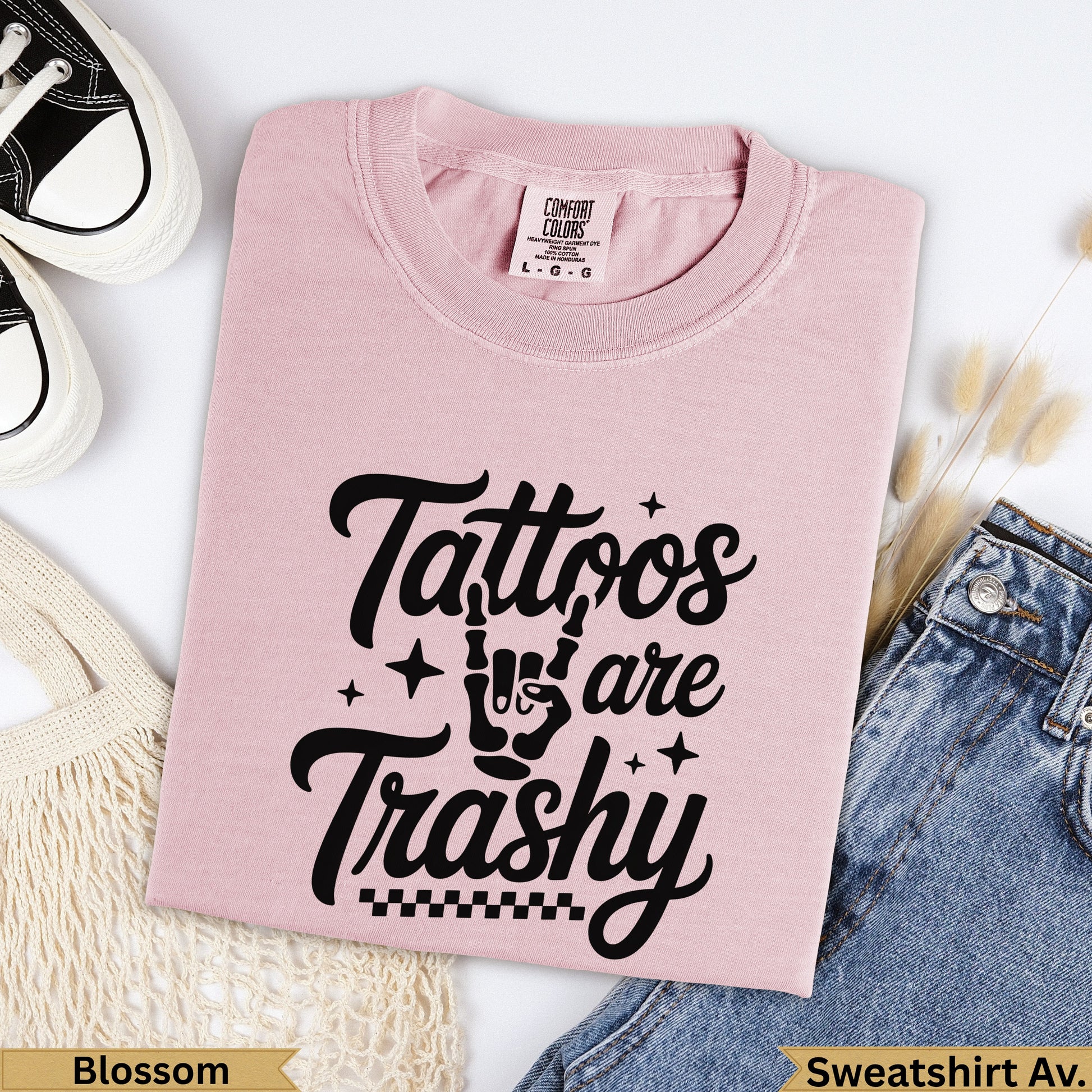 Pink Comfort Colors sweatshirt with "Tattoos are Trash" graphic.