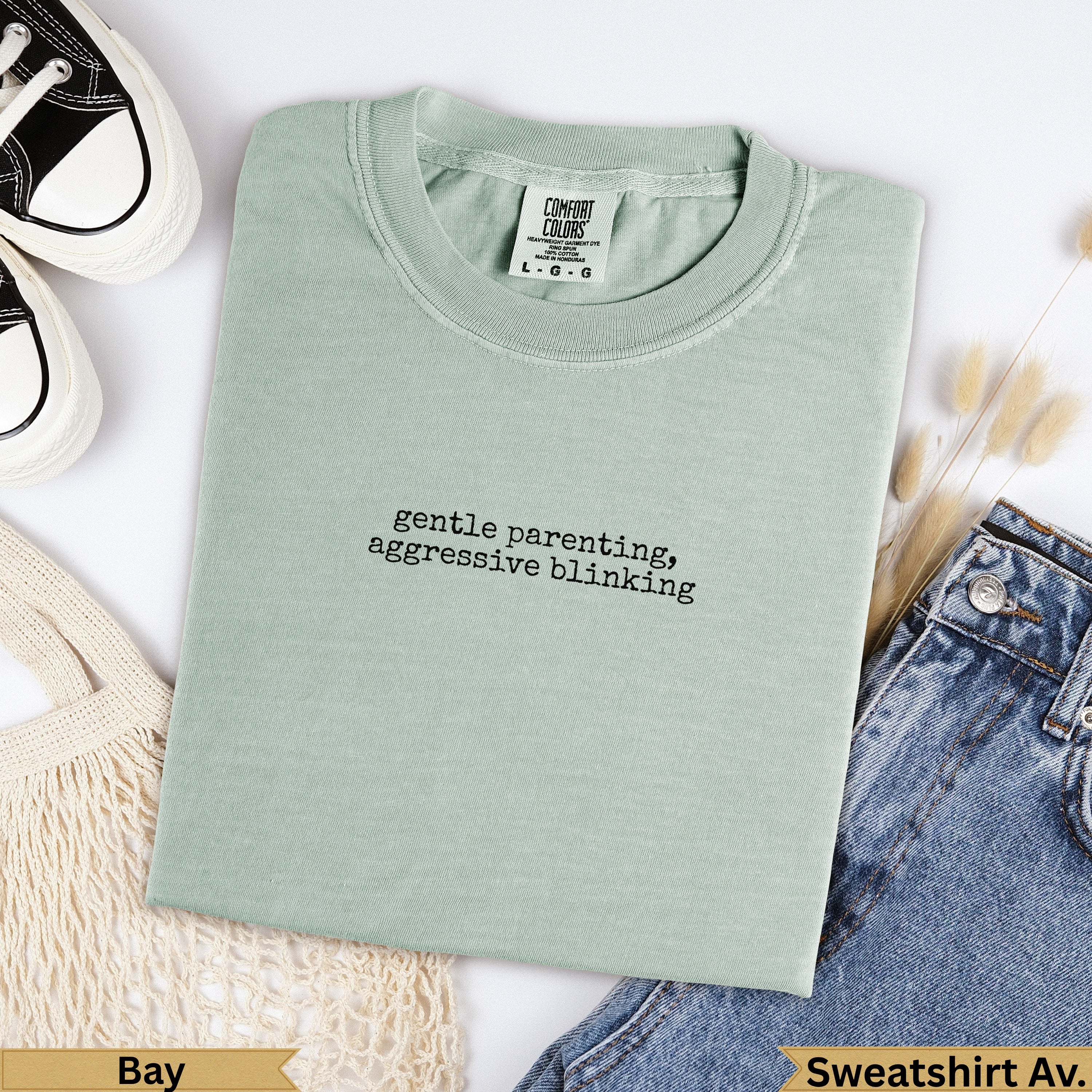 Comfort Colors light green crewneck sweatshirt with "gentle parenting, aggressive blinking" text.