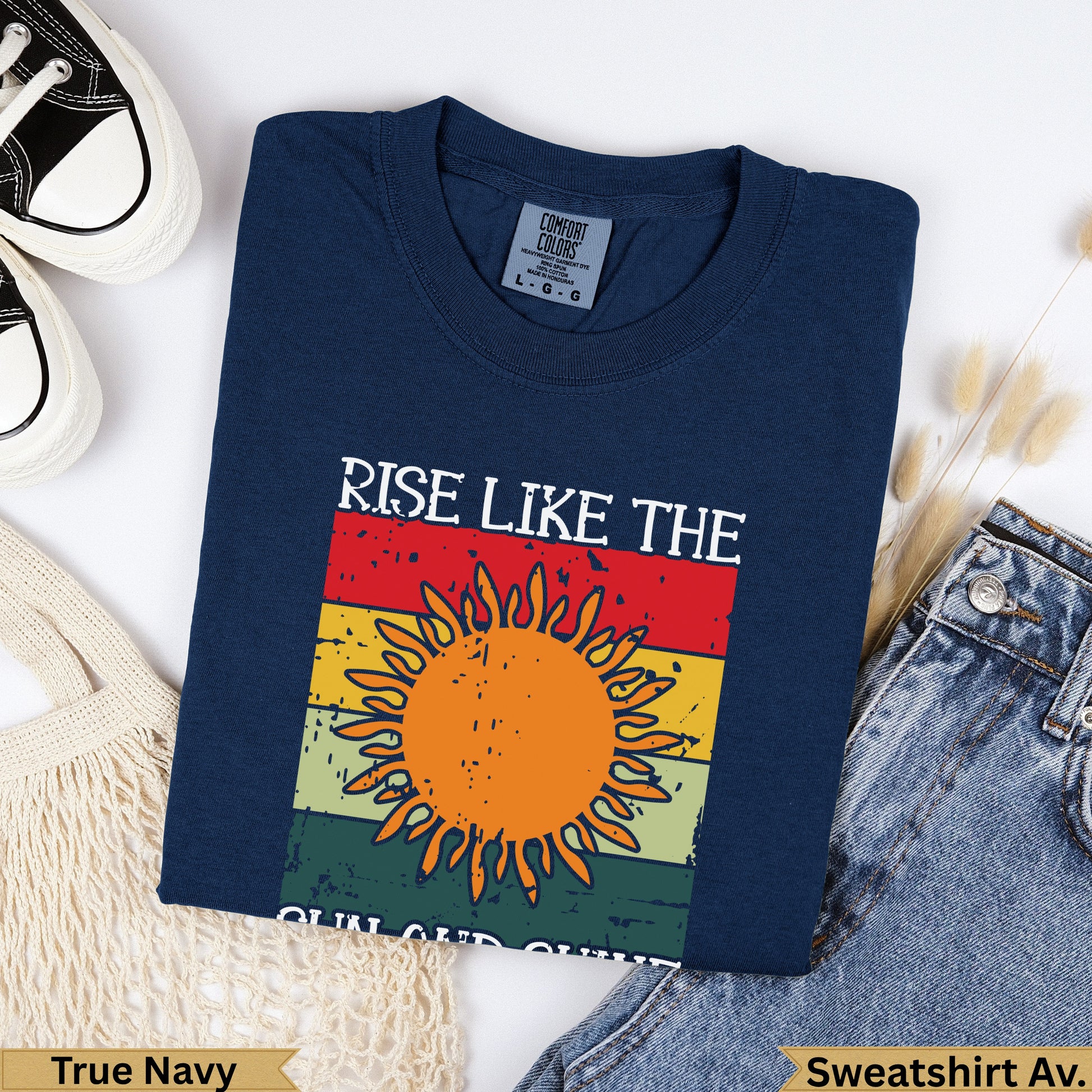 Navy t-shirt with "RISE LIKE THE SUN" graphic and sunburst design.