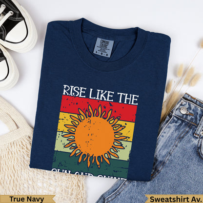 Navy t-shirt with "RISE LIKE THE SUN" graphic and sunburst design.