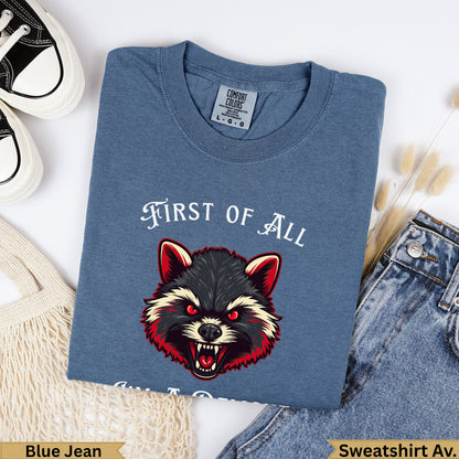 Blue jean t-shirt with a snarling raccoon and "FIRST OF ALL" text.