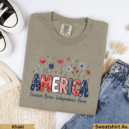 Khaki t-shirt with "AMERICA" in patriotic font and floral accents.
