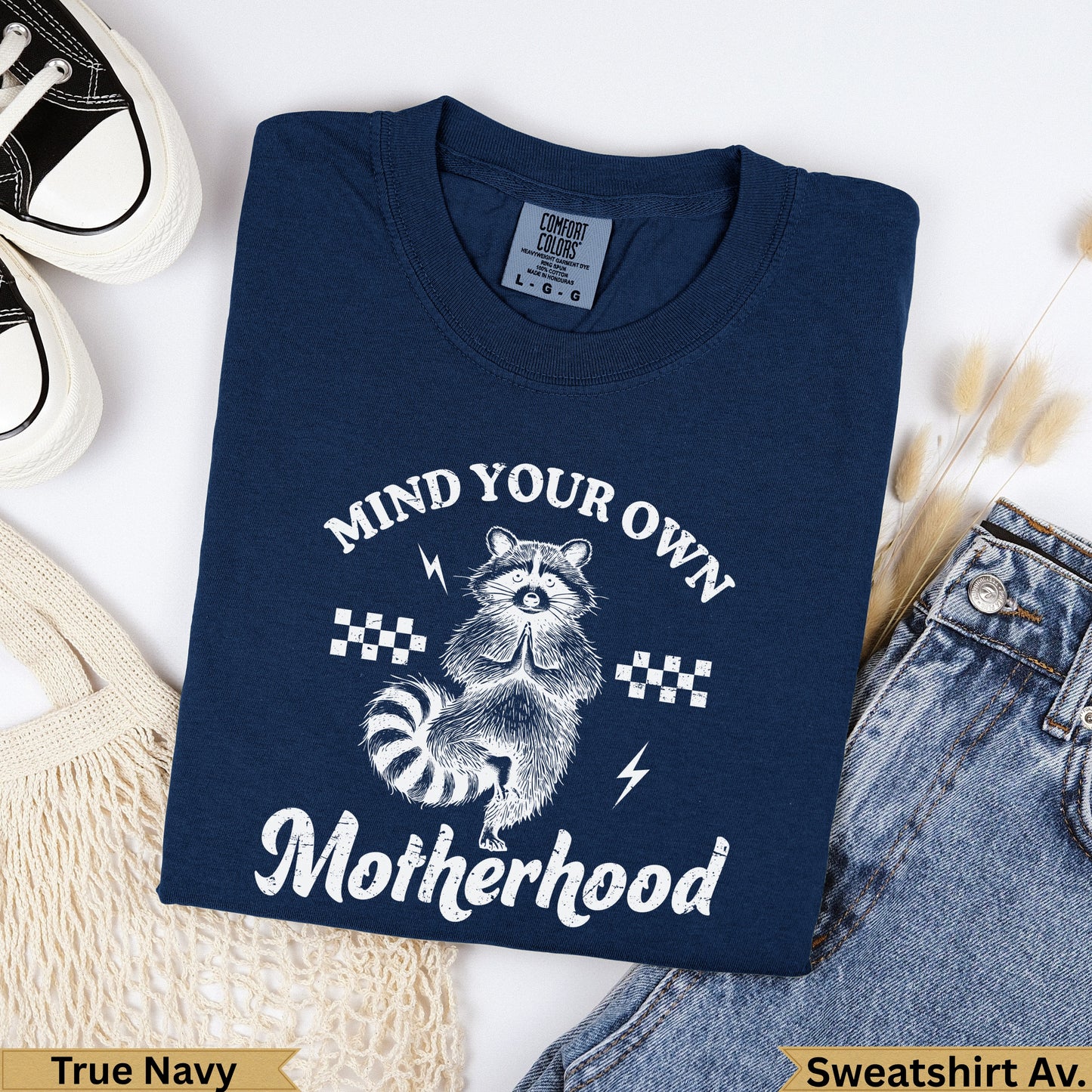Navy blue graphic sweatshirt with raccoon and "Mind Your Own Motherhood" text.