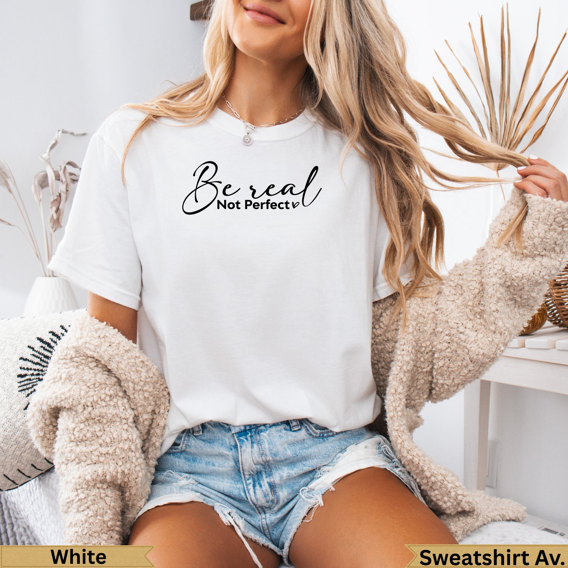 White t-shirt with "Be real Not perfect" text, worn by a woman.