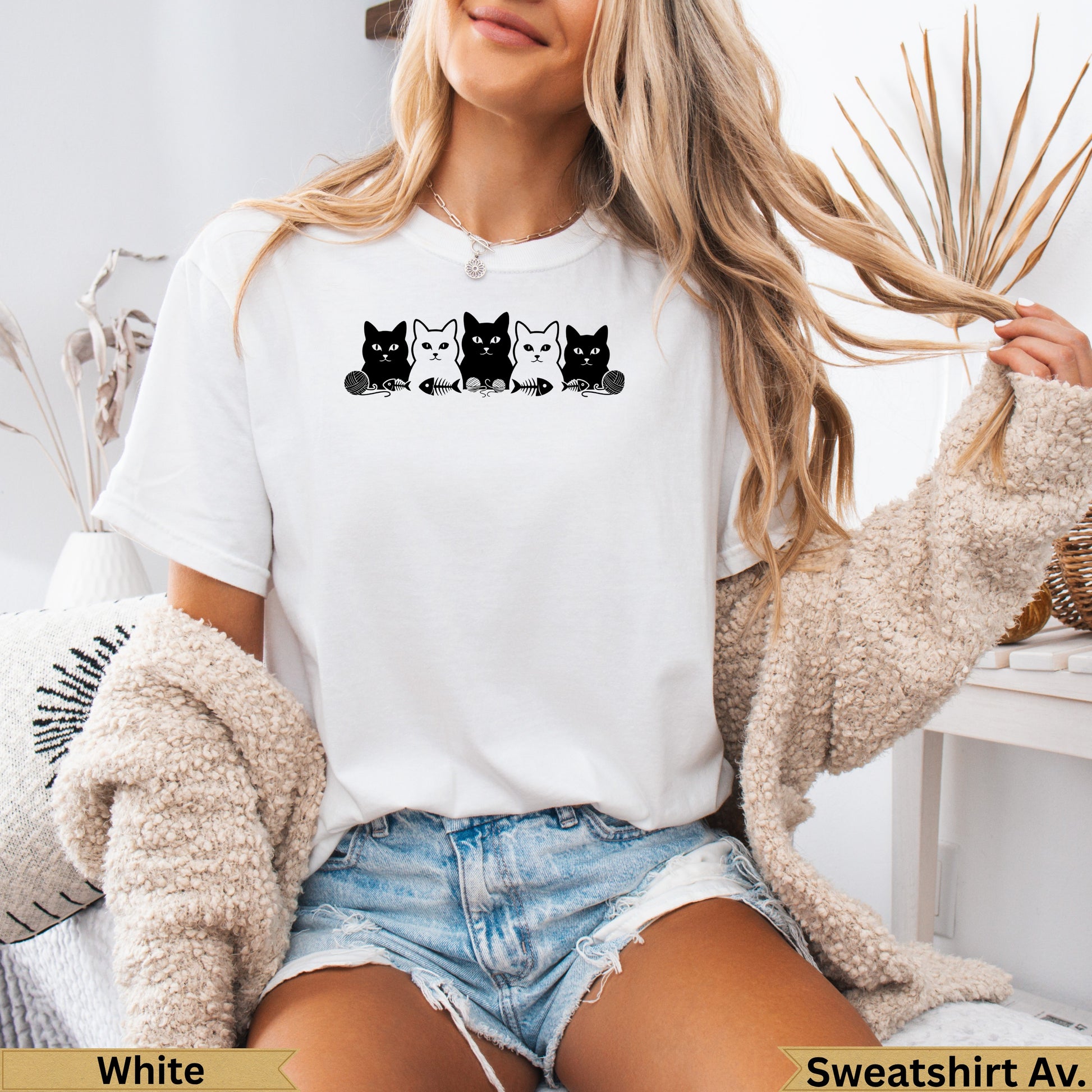 White t-shirt with black cat graphic and "Sweatshirt Av." text.