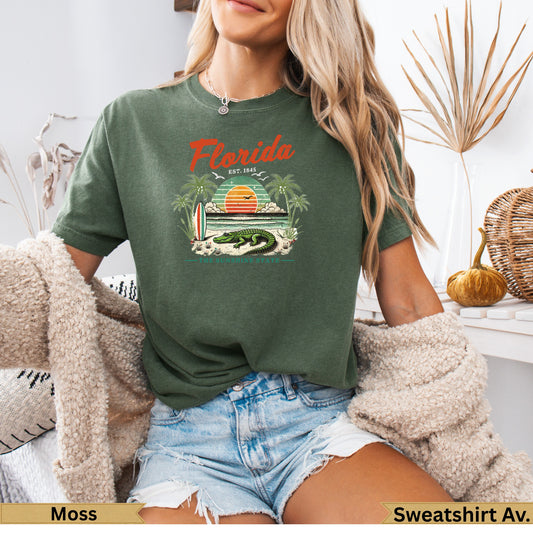 Green t-shirt with Florida, alligator, beach, and sunset graphic.