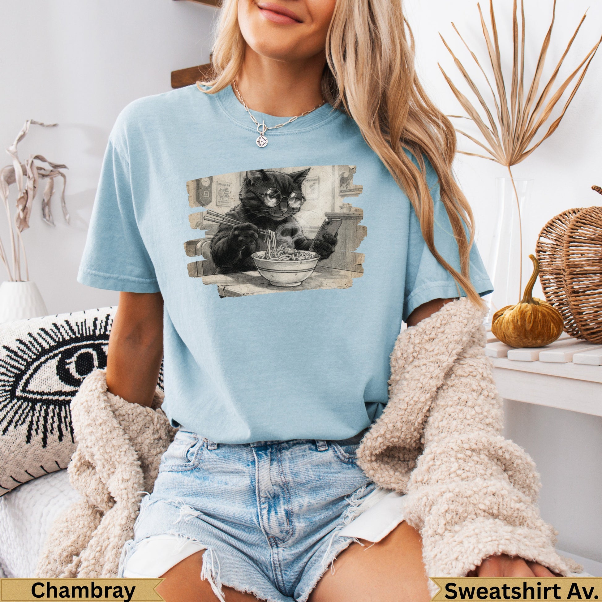 Light blue t-shirt with a black cat wearing glasses eating ramen.
