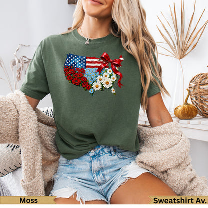 Green t-shirt with US map design of flowers and ribbon.