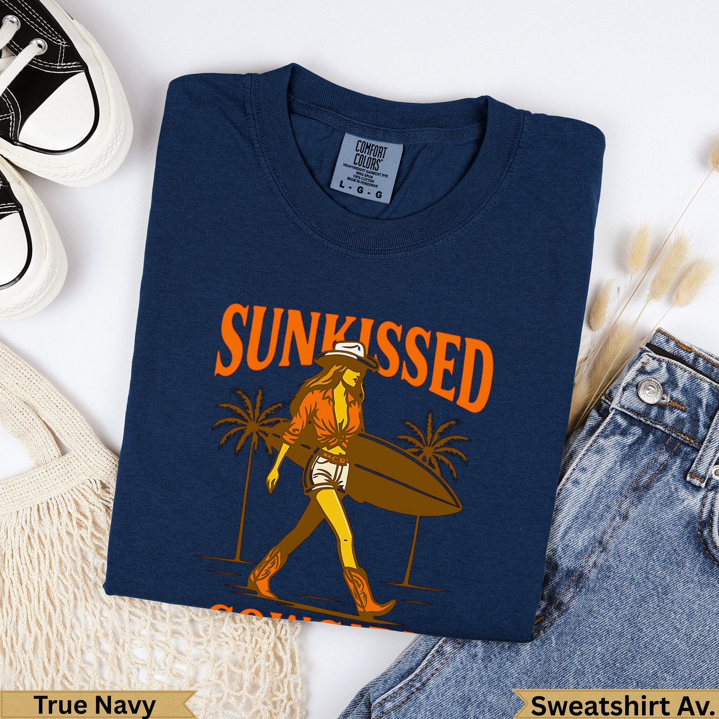 Navy t-shirt with "Sunkissed" graphic of a woman with surfboard and palm trees.