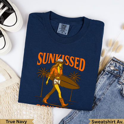 Navy t-shirt with "Sunkissed" graphic of a woman with surfboard and palm trees.