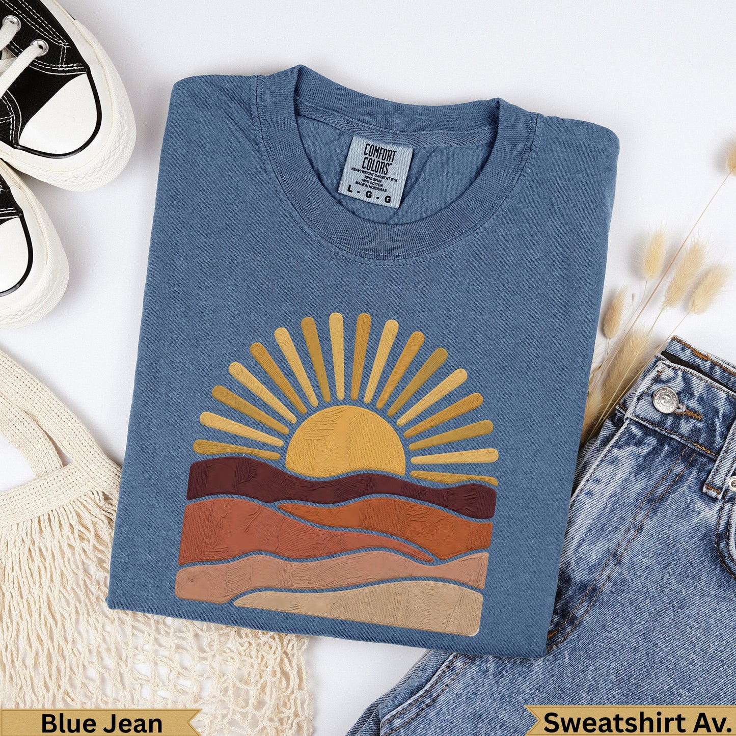Blue Jean Comfort Colors sweatshirt with a stylized sun and earth tone landscape design.