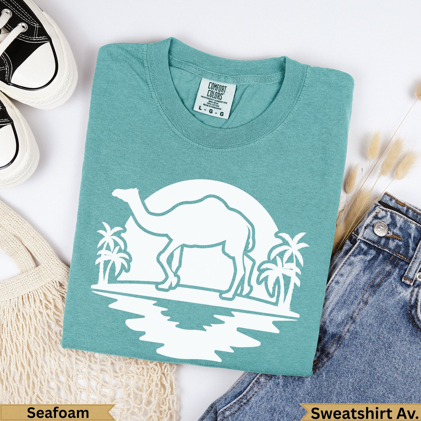 Teal Comfort Colors sweatshirt with white camel and palm tree graphic, 'Seafoam' label.