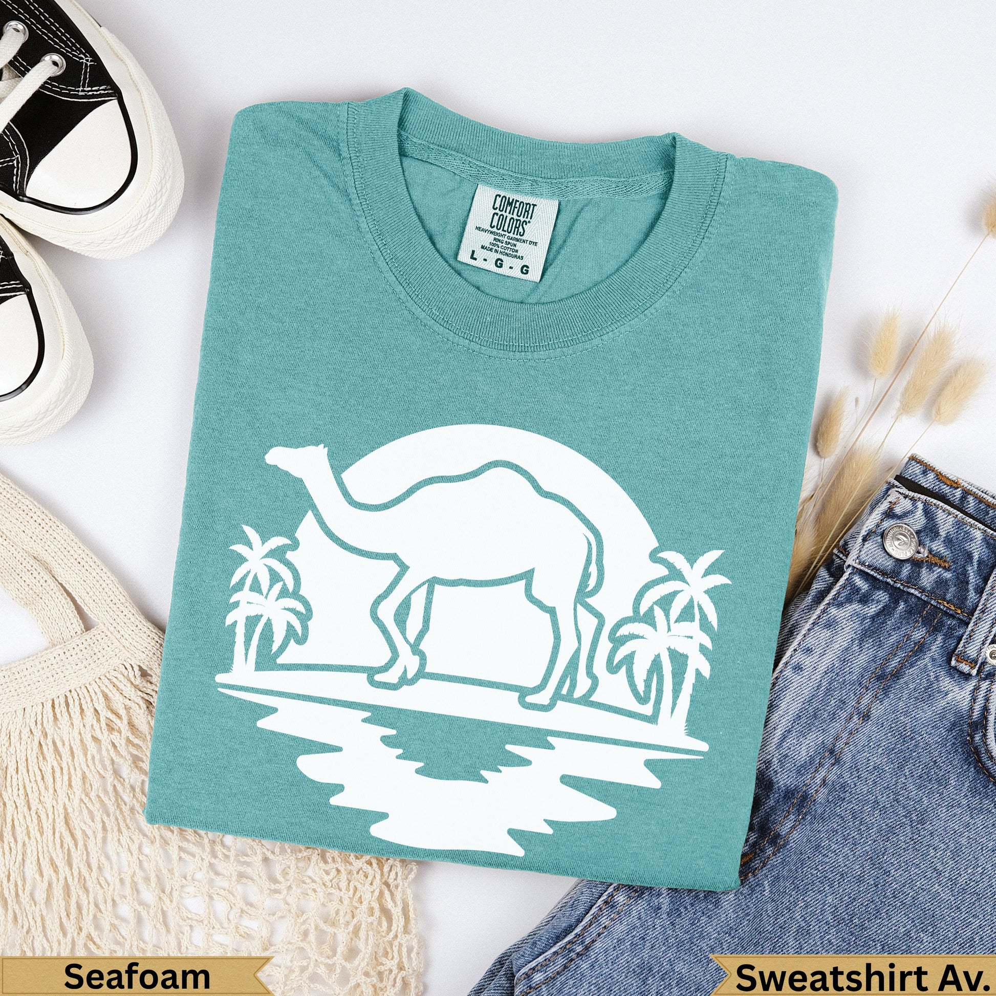 Teal Comfort Colors sweatshirt with white camel and palm tree graphic, 'Seafoam' label.