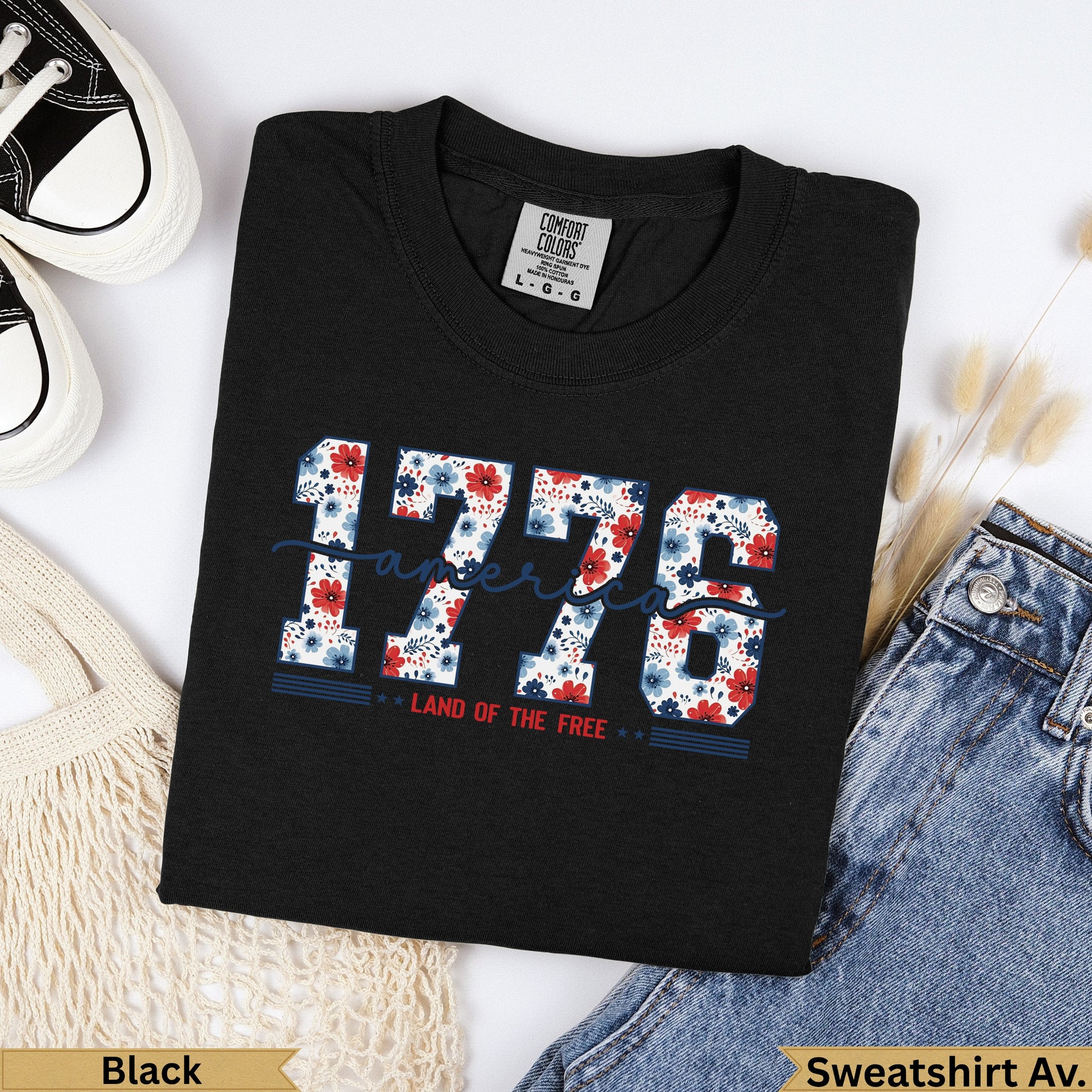 Black t-shirt with "1776 LAND OF THE FREE" in floral lettering.