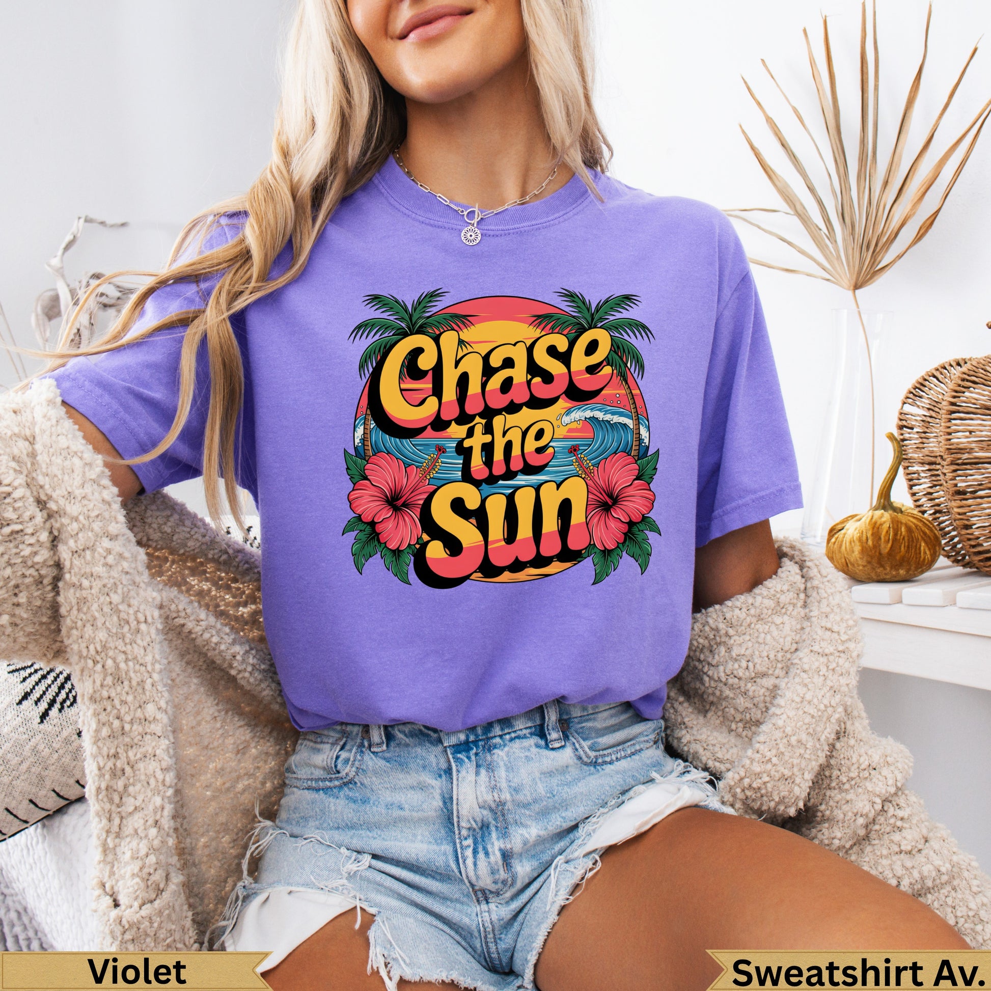 Purple t-shirt with "Chase the Sun" text and tropical floral design.