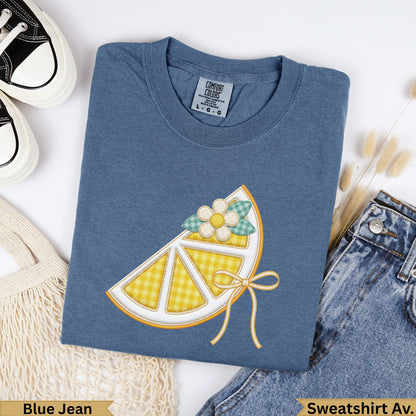 Blue Jean Comfort Colors sweatshirt with a lemon slice graphic and bow.