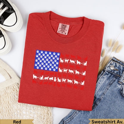 Red t-shirt with American flag pattern of paw prints and cats.