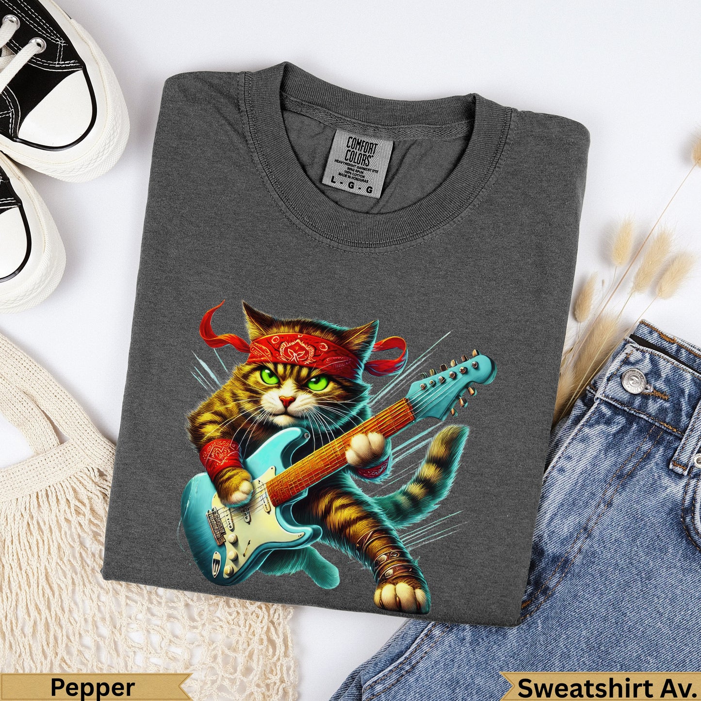 Graphic tee with a cat wearing a bandana and playing a blue electric guitar.