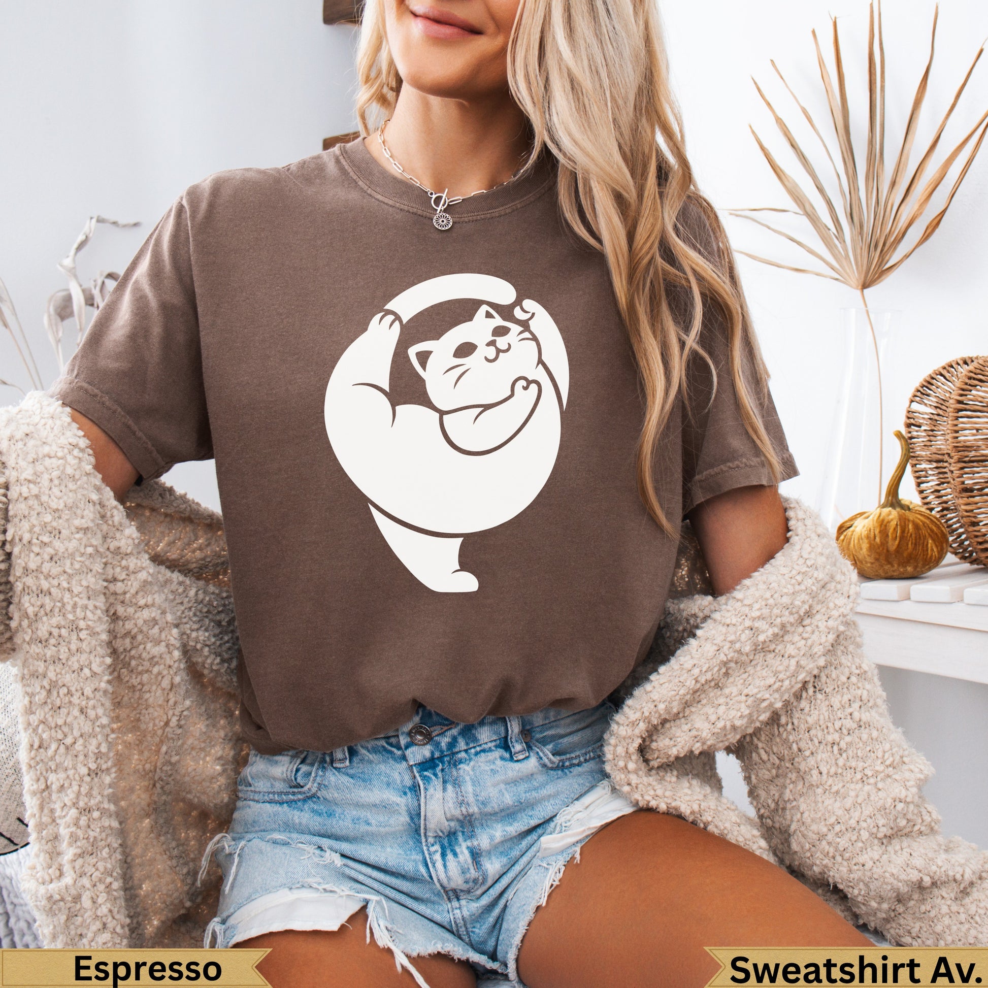 Brown sweatshirt with a white cat doing yoga pose on the front.