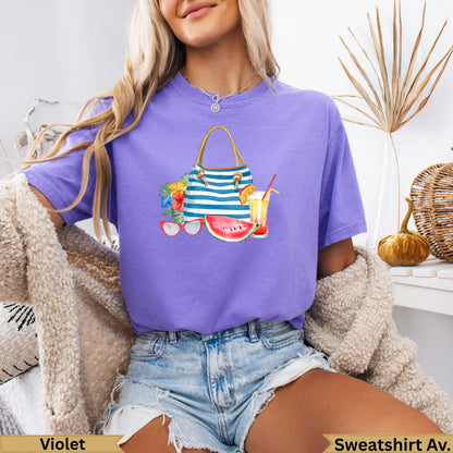 Purple t-shirt with beach bag, sunglasses, watermelon, and drink graphic.