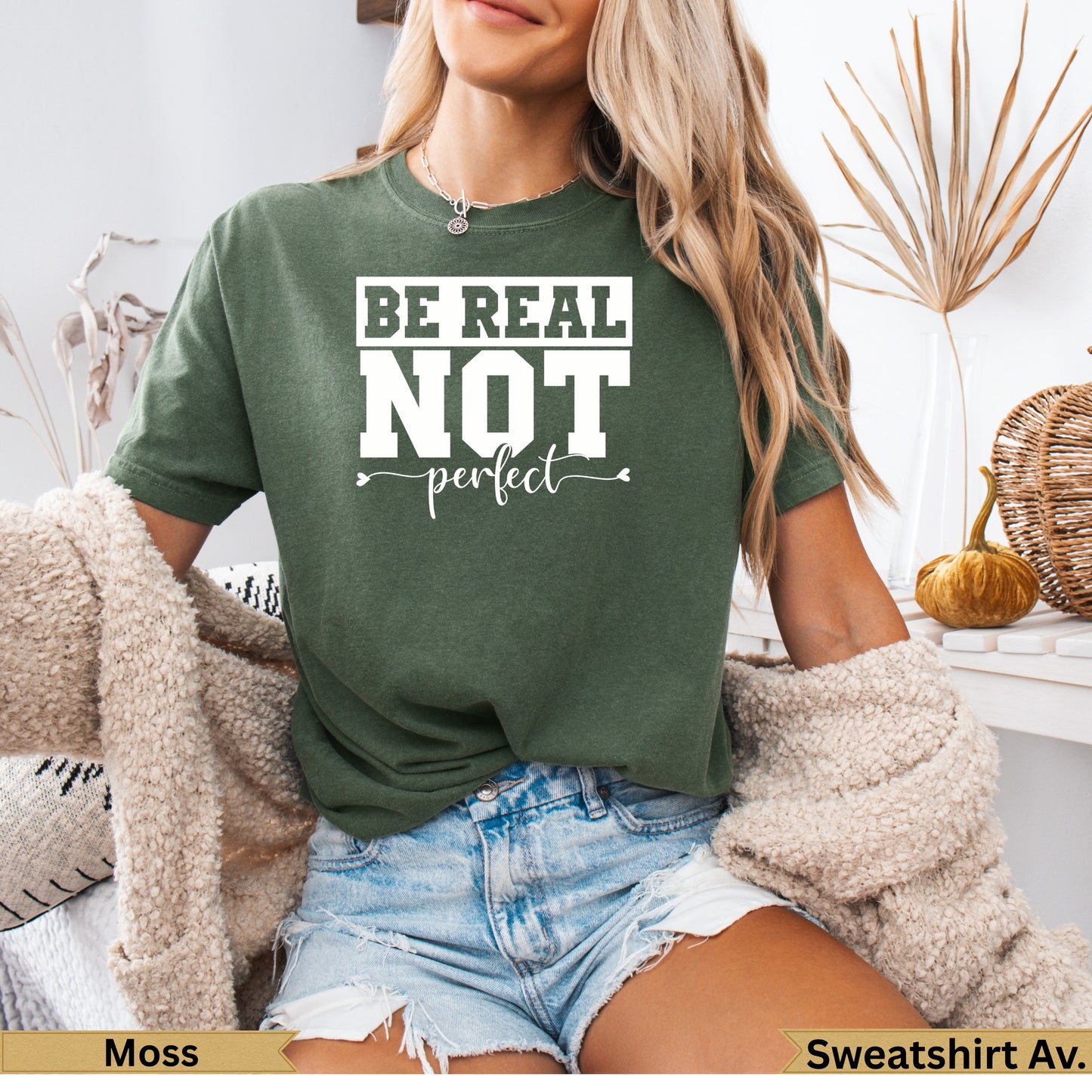 Moss green t-shirt with "BE REAL NOT perfect" text and heart detail.