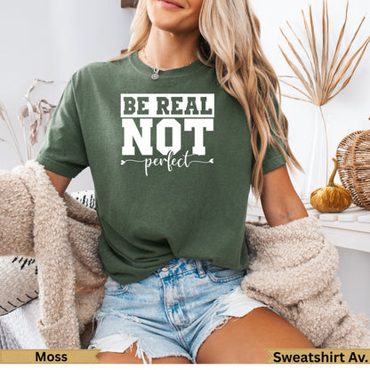 Moss green t-shirt with "BE REAL NOT perfect" text and heart detail.