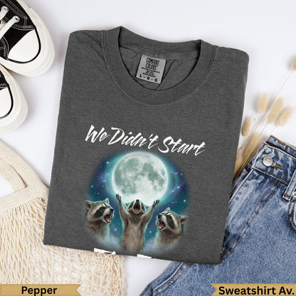 Three raccoons reaching towards a full moon with "We Didn't Start" text.