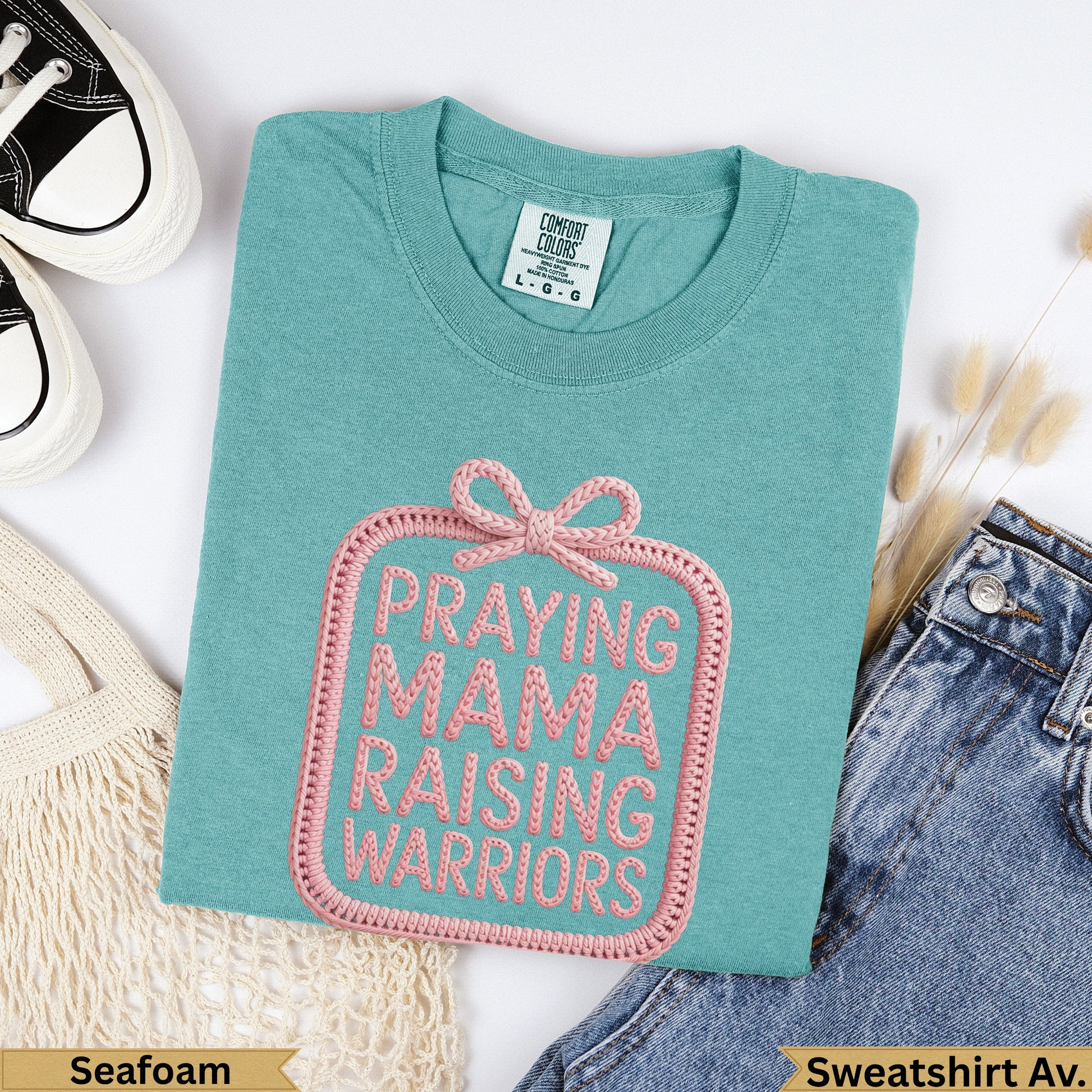 Seafoam Comfort Colors sweatshirt with pink embroidered "Praying Mama Raising Warriors" text.