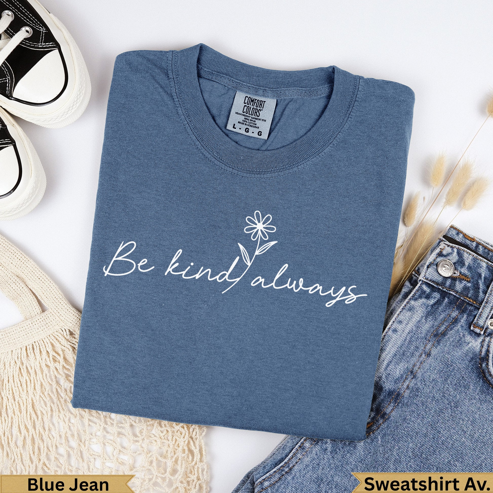 Dusty blue crewneck t-shirt with "Be kind always" and a daisy graphic.
