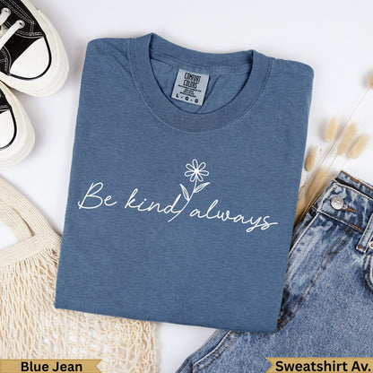 Dusty blue crewneck t-shirt with "Be kind always" and a daisy graphic.