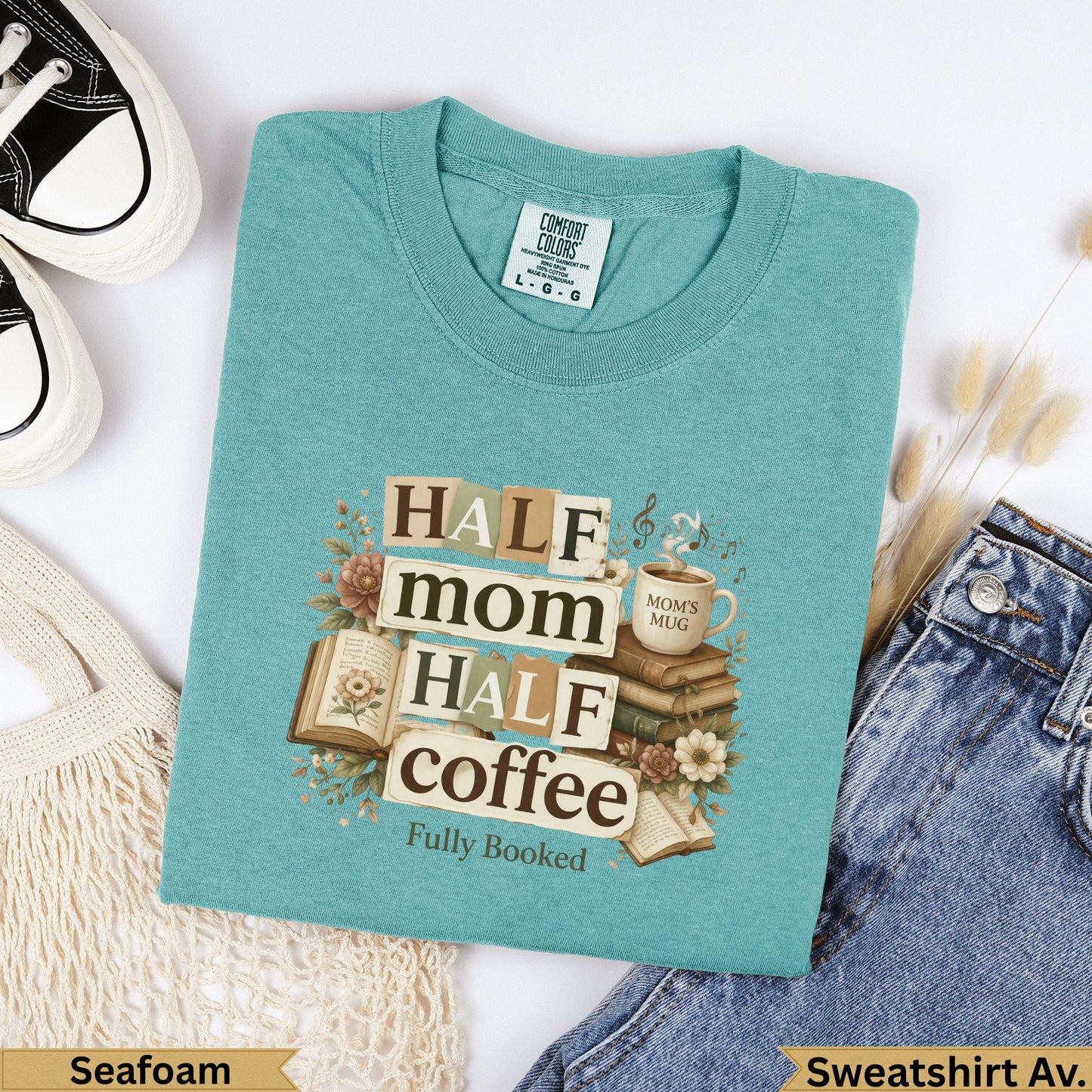 Seafoam sweatshirt with "Half mom, half coffee, fully booked" text and book illustrations.