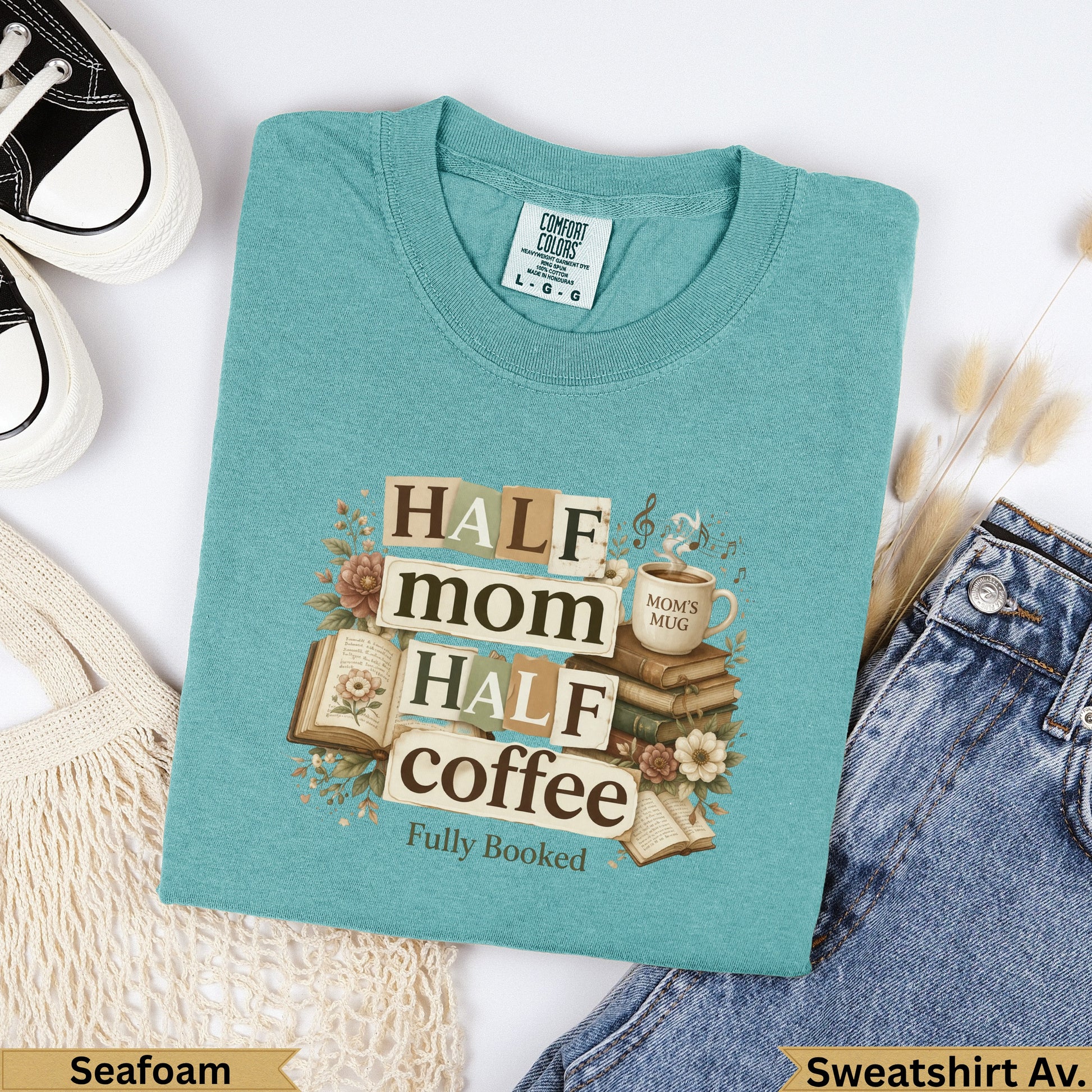 Seafoam sweatshirt with "Half mom, half coffee, fully booked" text and book illustrations.