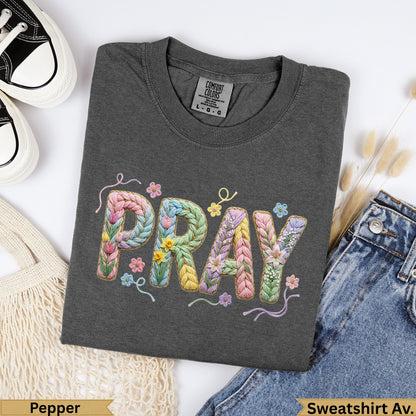 Dark gray sweatshirt with colorful floral "PRAY" embroidery.