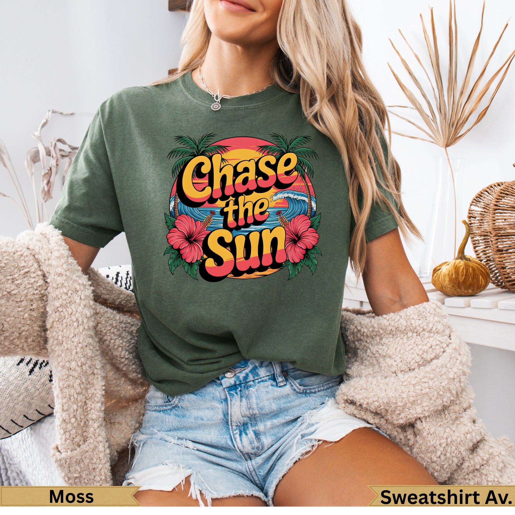 Green t-shirt with "Chase the Sun" text and tropical design.