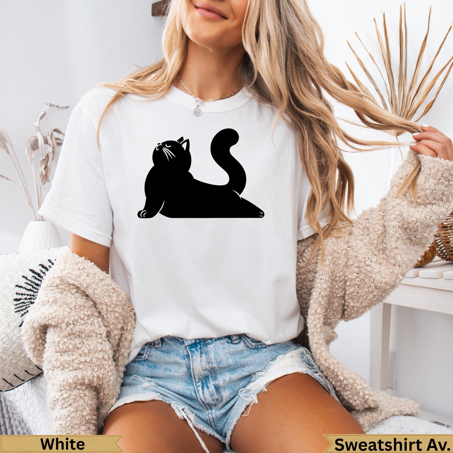 Black silhouette of a cat on a white t-shirt.