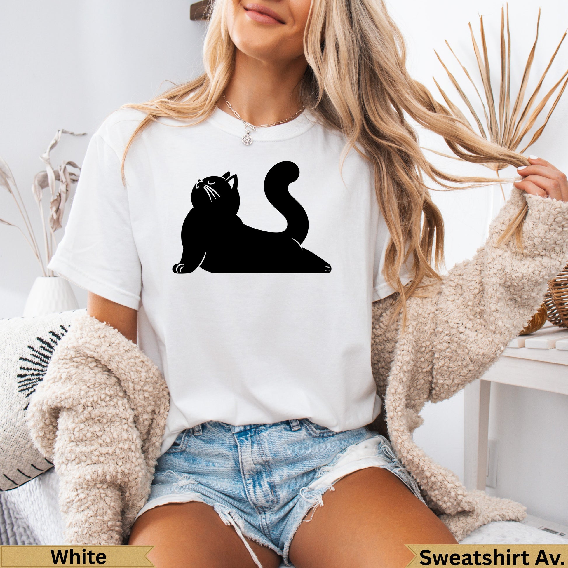 Black silhouette of a cat on a white t-shirt.
