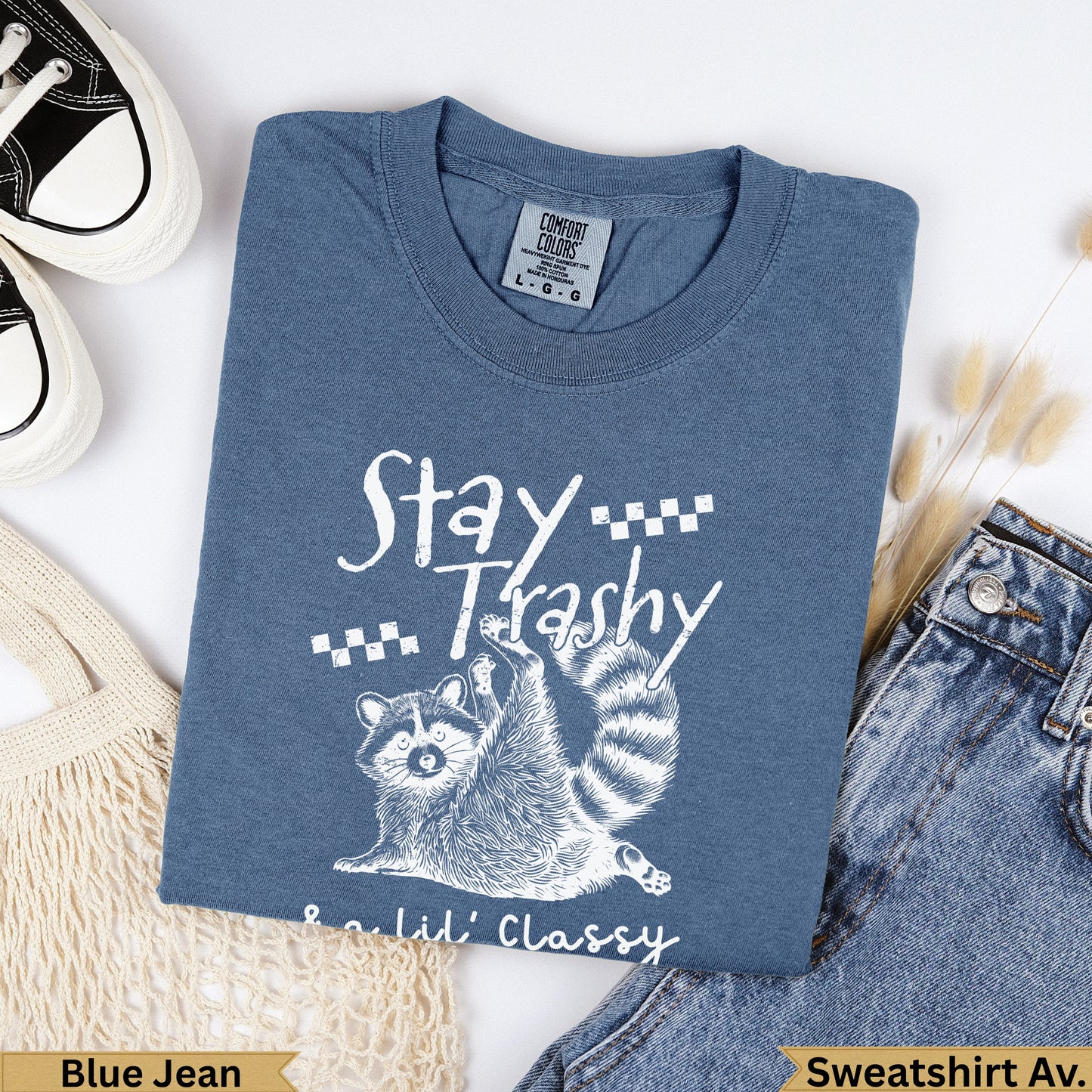 Blue Jean Comfort Colors sweatshirt with raccoon and "Stay Trashy Lil' Classy" text.